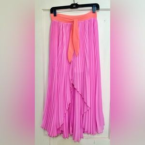 Impeccable Pig: Pink pleated midi skirt with coral color blocking